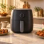 Centered compact air fryer with paneer tikka, samosas, chai and subtle Holi colours in an Indian kitchen
